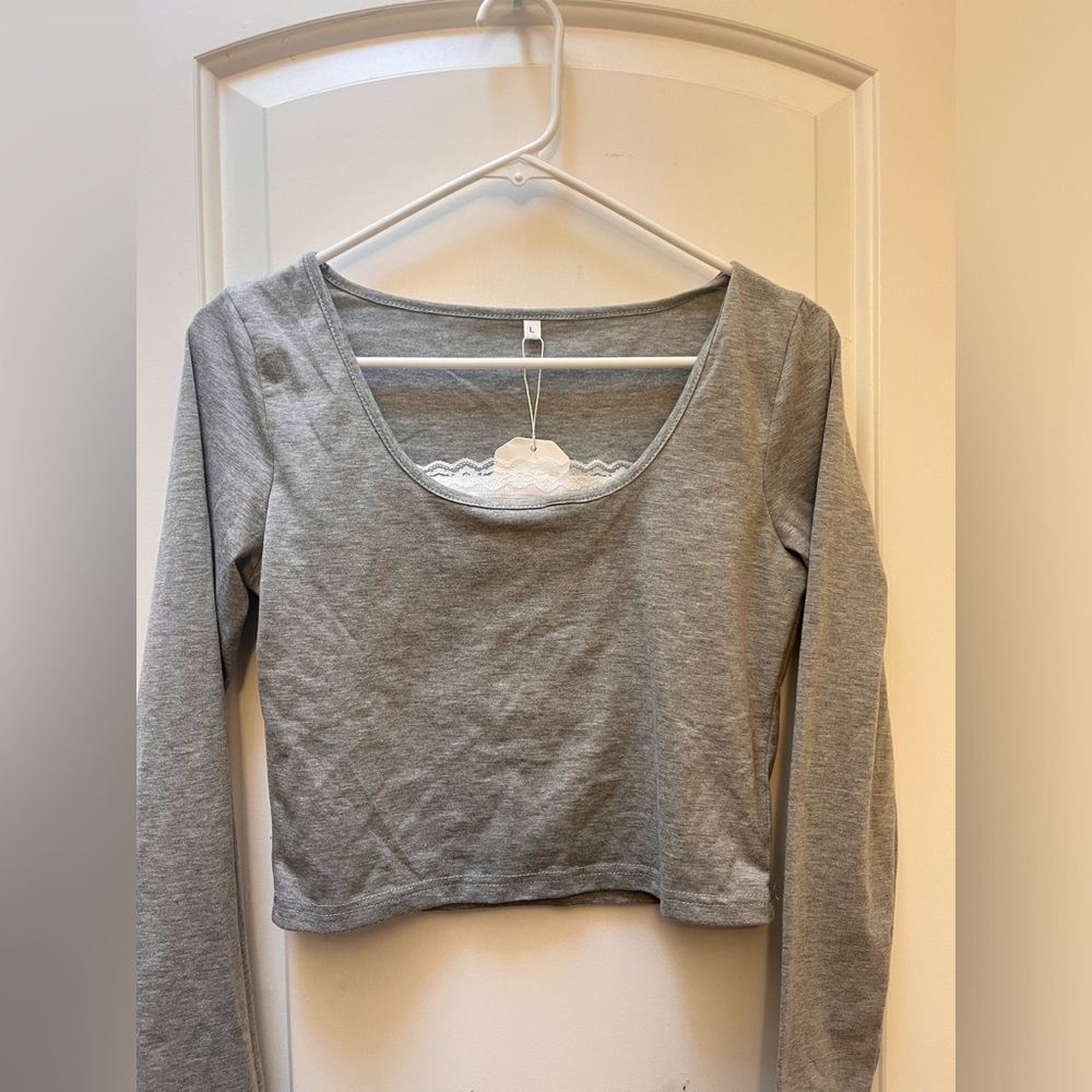 Grey long sleeve crop top with fake undershirt attached.